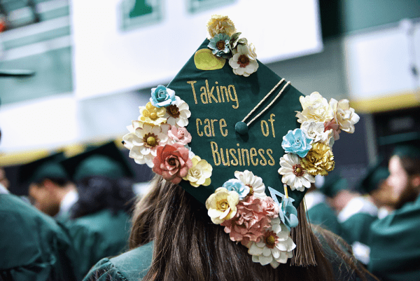 graduation cap at winter 2023 commencement that says "taking care of business"