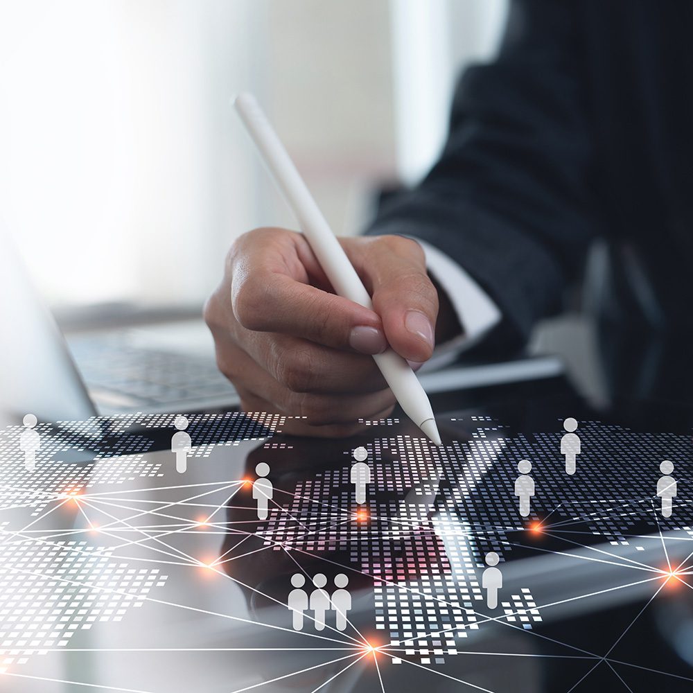 Management Programs: human resource management concentration. Person sitting at a desktop digital board mapping out a human resource plan with a stylus.