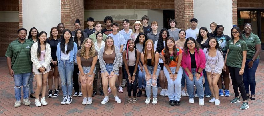 Group photo of FIT for Business students in front of the Friday Building