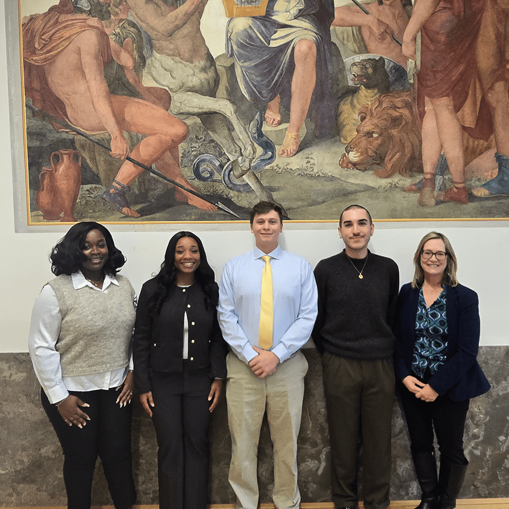 Gabriella Crentsil, Eunice Okyere and Isaac Nechvatal ‘24 (left to right) gained high marks for their research, presented in Munich, Germany at a seminar on risk and insurance, joined by graduate assistant Brandon Turner and Associate Professor Faith Neale.