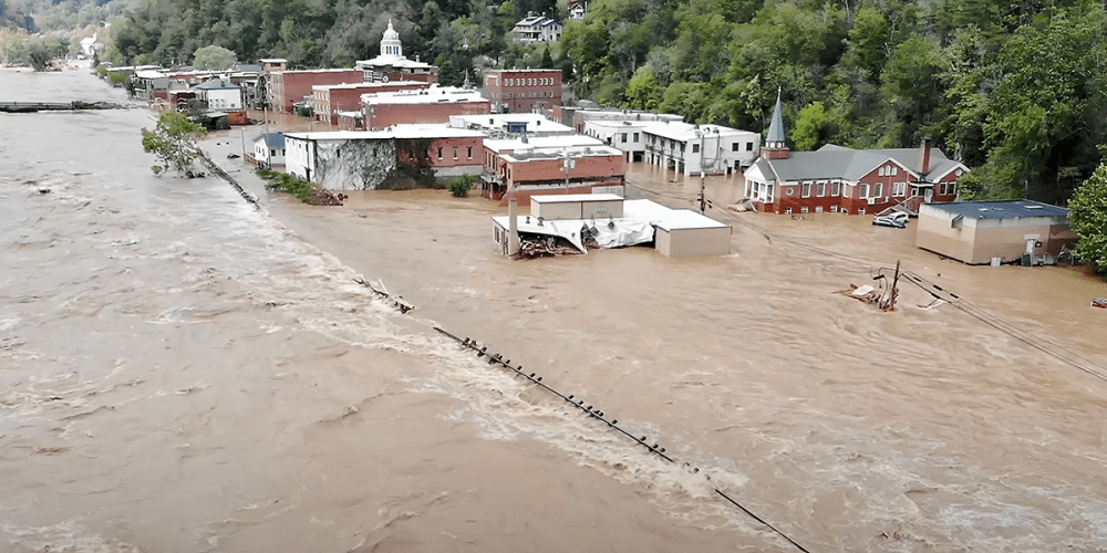 Rising floodwaters from the French Broad River engulf Marshall Presbyterian Church (second building, right) and every other structure in downtown Marshall. A water line left by receding flood water is visible just below sanctuary windows. Photo courtesy of LCD Mountain Aerial Photography